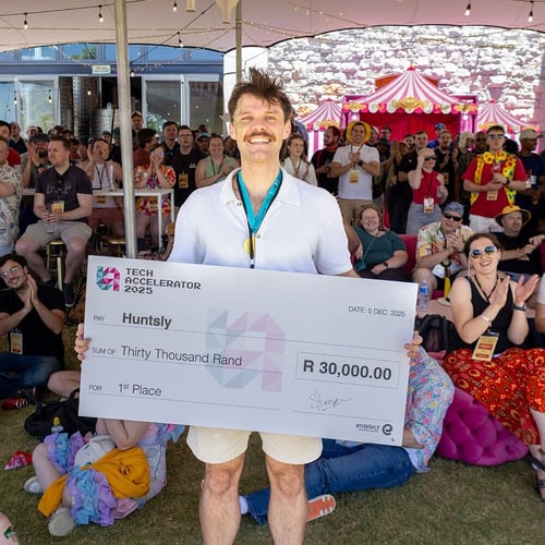 Tech Accelerator winner holding a prize cheque